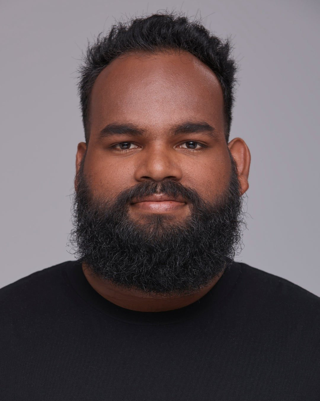 Model wearing The MATTERfying Foundation in Shade 30 Fate, showcasing a flawless matte finish. Her tan skin with olive undertones appears smooth, even, and shine-free, highlighting the foundation’s natural-looking, full-coverage formula